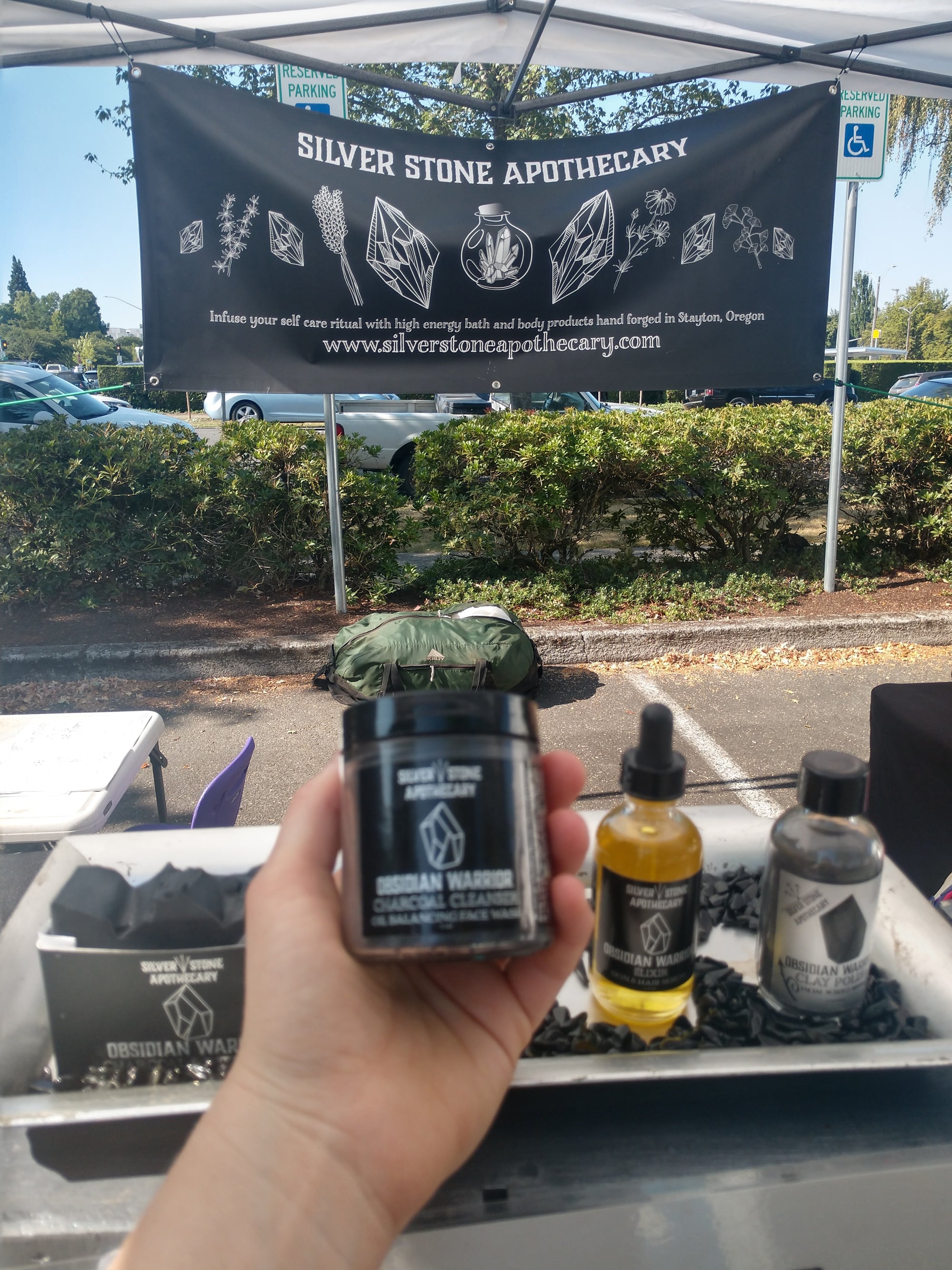 apothecary display at farmer's market with charcoal cleanser